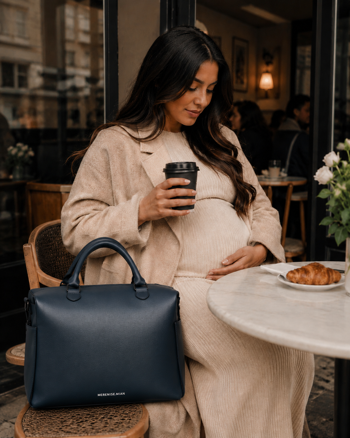 Expectant mother at a café with the bag on the chair beside her